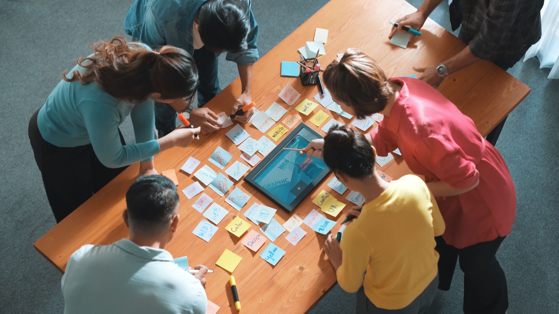 Top view of manager writing idea on sticky notes and explain idea. Symposium.